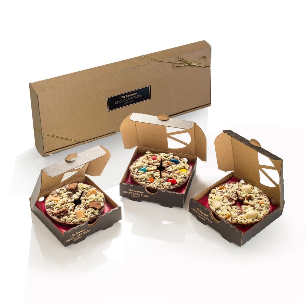 A trio of mini chocolate pizzas, presented in a kraft brown gift box